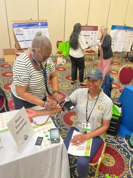 Photo of woman having her blood pressure checked at a RespondDE event