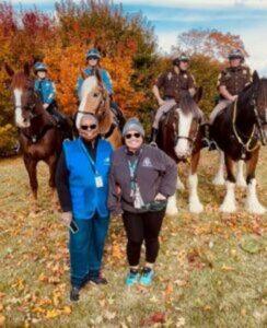 Photo of RespondDE volunteers at an event. Mounted police in background.